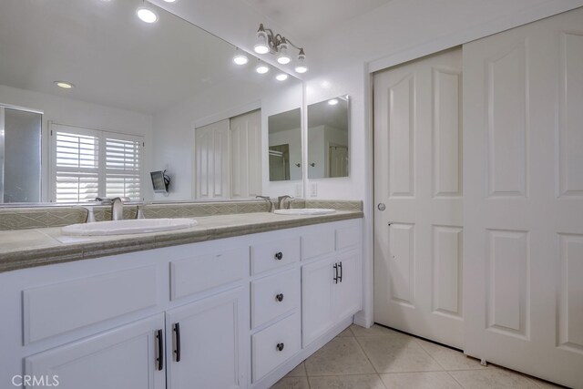 bathroom with tile patterned flooring and vanity