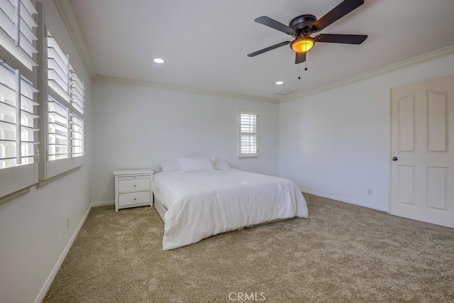 carpeted bedroom featuring ornamental molding and ceiling fan