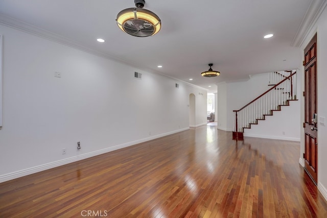 unfurnished living room with ornamental molding and dark hardwood / wood-style flooring