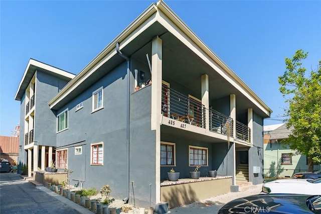 view of side of property featuring a balcony