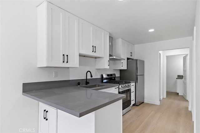 kitchen with white cabinets, kitchen peninsula, sink, and gas range