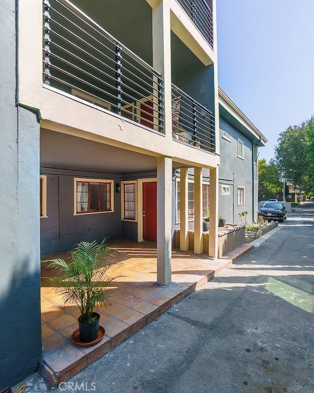 view of exterior entry featuring a balcony