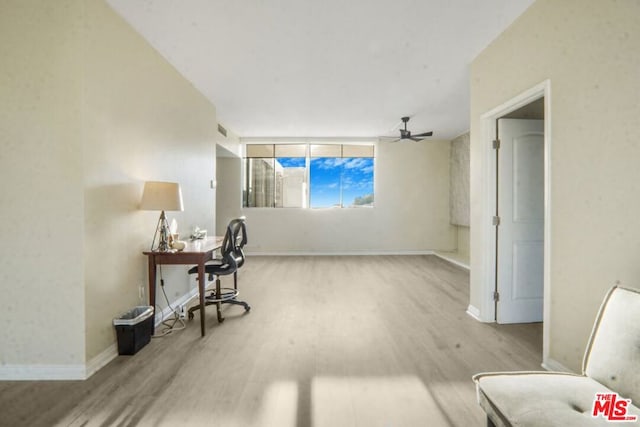 living area with light wood-type flooring and ceiling fan