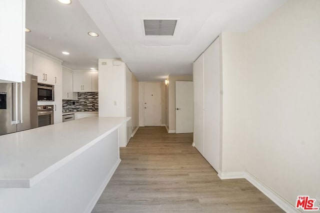 hallway featuring light wood-type flooring