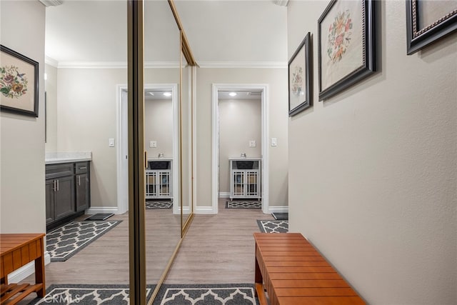 hall with crown molding and light wood-type flooring