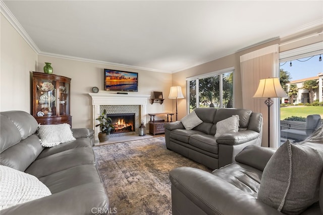 living room featuring crown molding and a tile fireplace