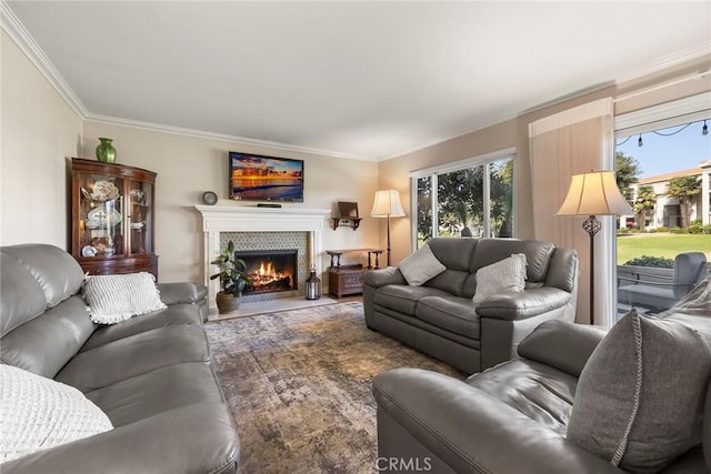 living room with a healthy amount of sunlight, a fireplace, and crown molding