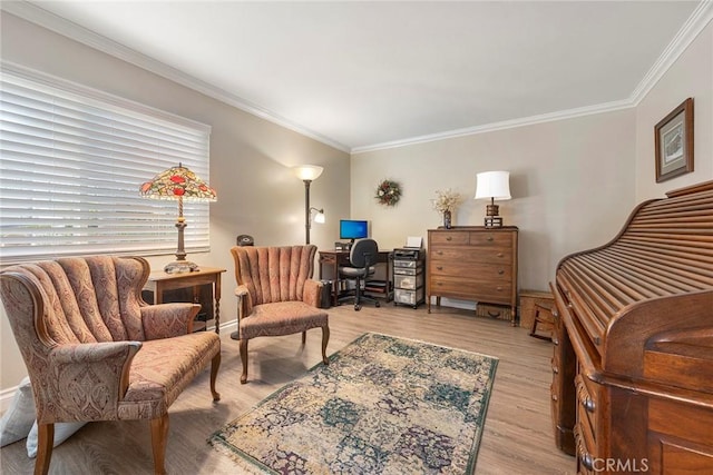 living area featuring baseboards, ornamental molding, and wood finished floors