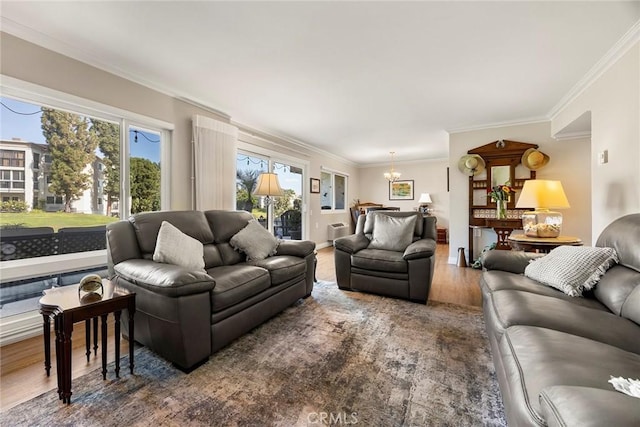 living room with wood finished floors, an inviting chandelier, and crown molding