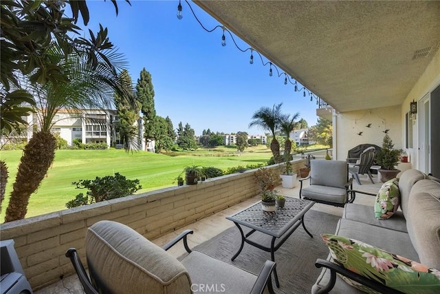 exterior space featuring outdoor lounge area, visible vents, and view of golf course