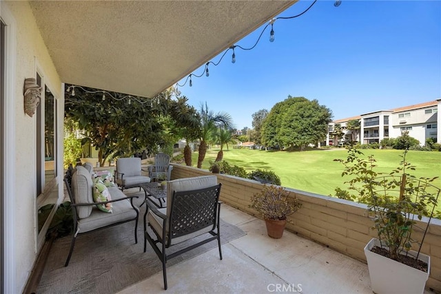 balcony featuring a patio, view of golf course, and an outdoor hangout area