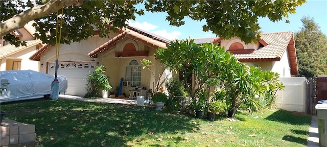 view of front of property with a front lawn and a garage