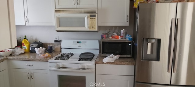 kitchen with stainless steel appliances and white cabinets