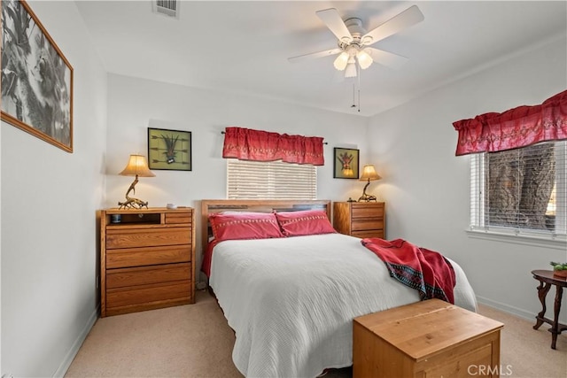 bedroom with ceiling fan and light carpet