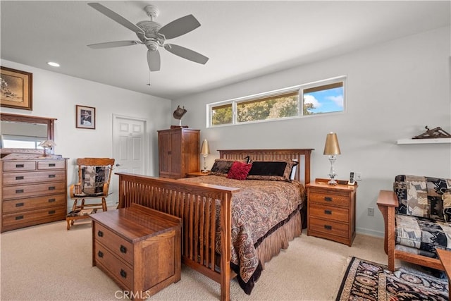 bedroom featuring light colored carpet and ceiling fan