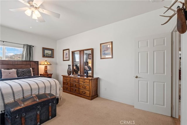 bedroom with ceiling fan and light carpet