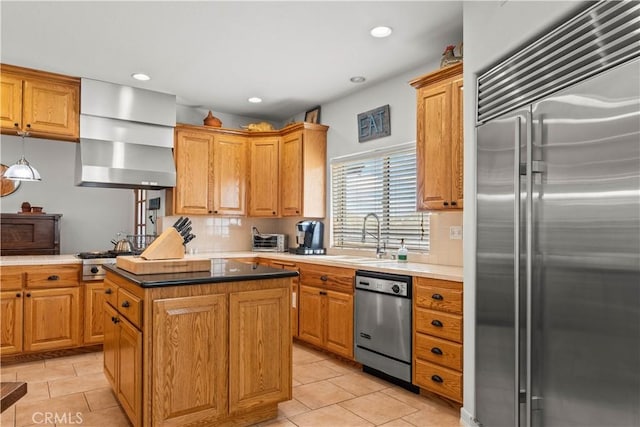 kitchen featuring sink, a center island, light tile patterned floors, and appliances with stainless steel finishes