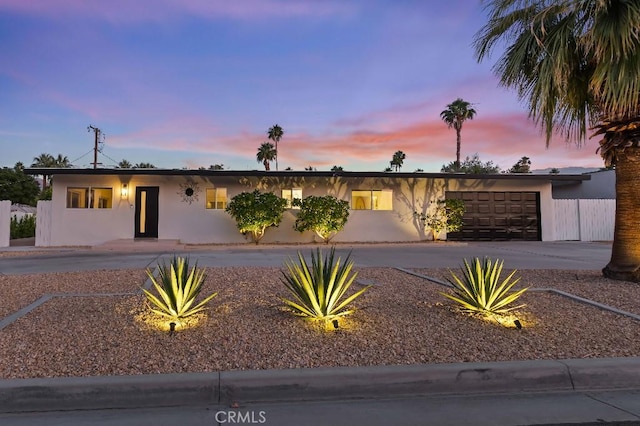 74279 Old Prospector Trl, Palm Desert, CA 92260 - view of front facade featuring an attached garage, stucco siding, and driveway