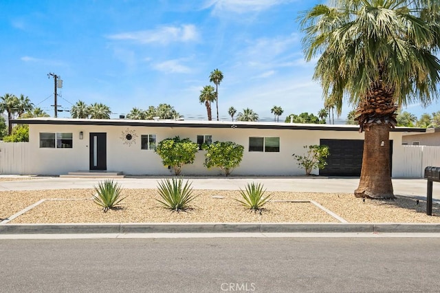 74279 Old Prospector Trl, Palm Desert, CA 92260 - ranch-style home featuring concrete driveway, stucco siding, an attached garage, and fence