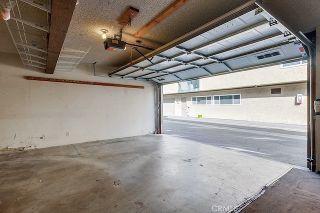 garage with a carport and a garage door opener