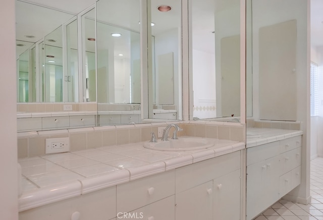 bathroom with tile patterned floors and vanity