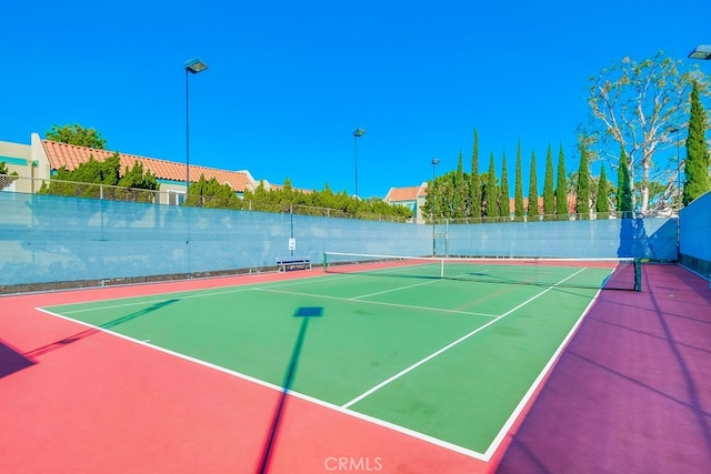 view of tennis court featuring basketball court