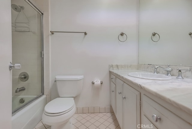 full bathroom featuring tile patterned flooring, vanity, toilet, and bath / shower combo with glass door