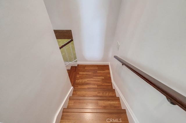 stairs featuring hardwood / wood-style floors