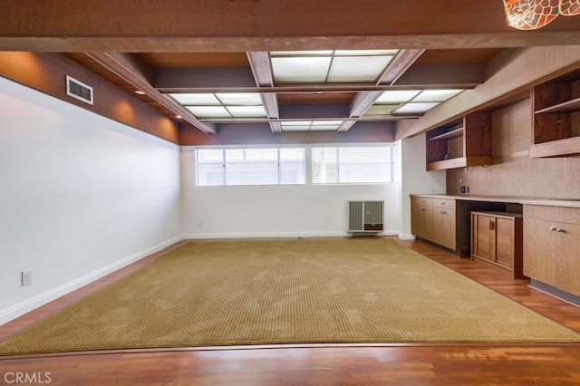 kitchen featuring beam ceiling, light hardwood / wood-style flooring, and coffered ceiling