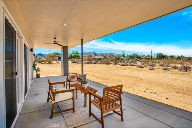 view of patio / terrace with a mountain view and ceiling fan