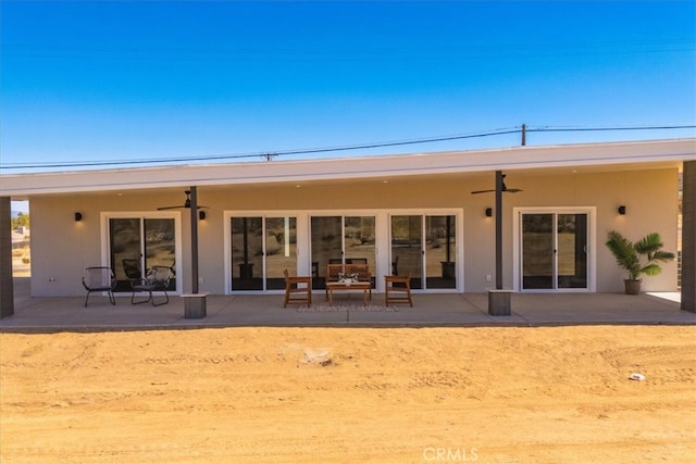 rear view of property featuring a patio and ceiling fan