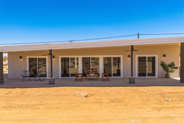 6614 Sunset Rd, Joshua Tree, CA 92252 - back of house featuring a ceiling fan, a patio area, and stucco siding