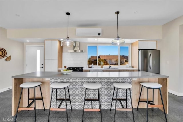 6614 Sunset Rd, Joshua Tree, CA 92252 - kitchen featuring freestanding refrigerator, wall chimney range hood, range, a breakfast bar, and recessed lighting