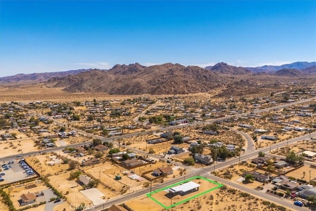 6614 Sunset Rd, Joshua Tree, CA 92252 - aerial view of property and surrounding area with property boundaries highlighted, a mountain backdrop, and a desert landscape