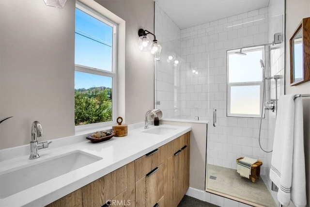 bathroom with a wealth of natural light, an enclosed shower, and vanity