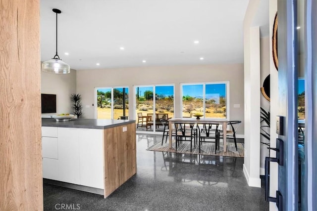 6614 Sunset Rd, Joshua Tree, CA 92252 - kitchen with white cabinetry, recessed lighting, modern cabinets, hanging light fixtures, and dark countertops