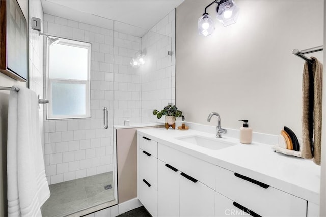 bathroom with walk in shower and vanity