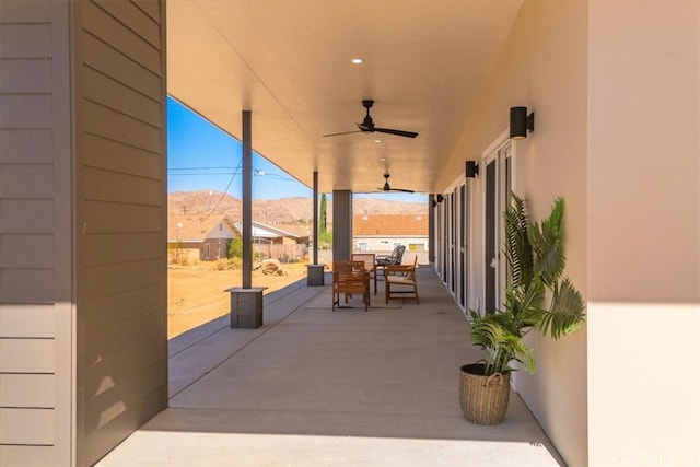 view of patio with a mountain view and ceiling fan