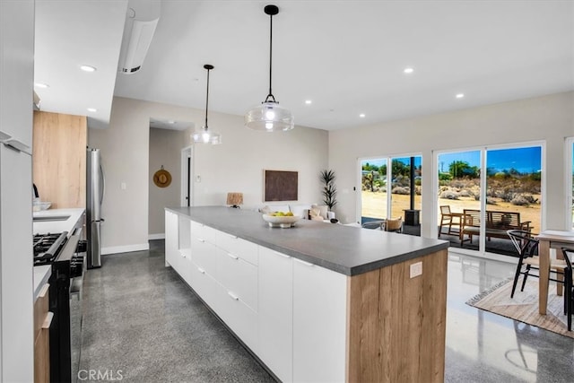 kitchen featuring a center island, white cabinetry, decorative light fixtures, and stainless steel appliances