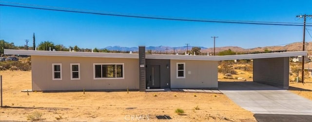 6614 Sunset Rd, Joshua Tree, CA 92252 - single story home featuring a mountain view, driveway, and a carport