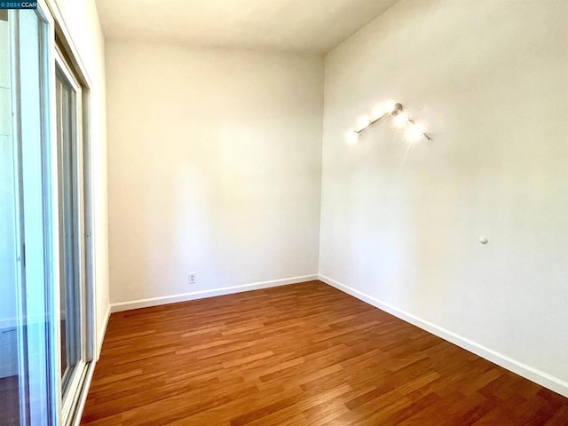 empty room with hardwood / wood-style floors