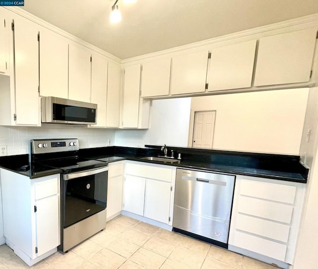 kitchen with white cabinetry, stainless steel appliances, and sink