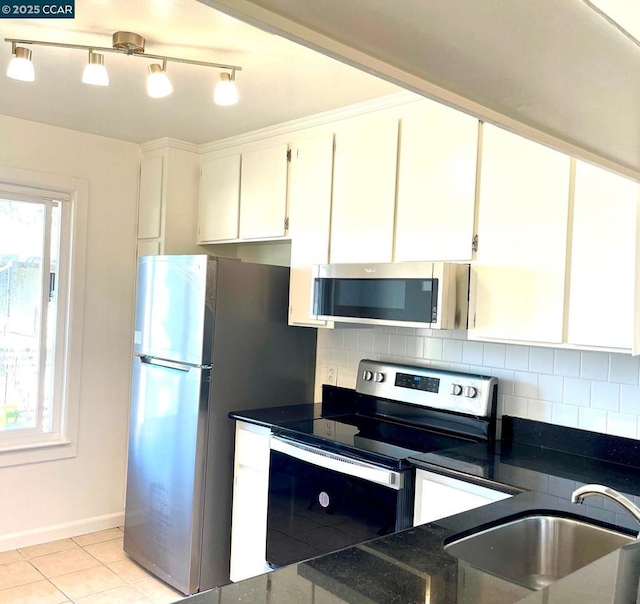 kitchen with white cabinetry, sink, tasteful backsplash, and stainless steel appliances