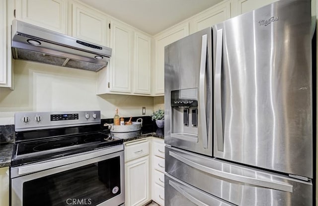 kitchen with appliances with stainless steel finishes, white cabinetry, range hood, and dark stone countertops