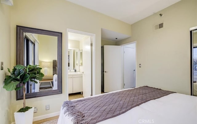 bedroom featuring baseboards and visible vents