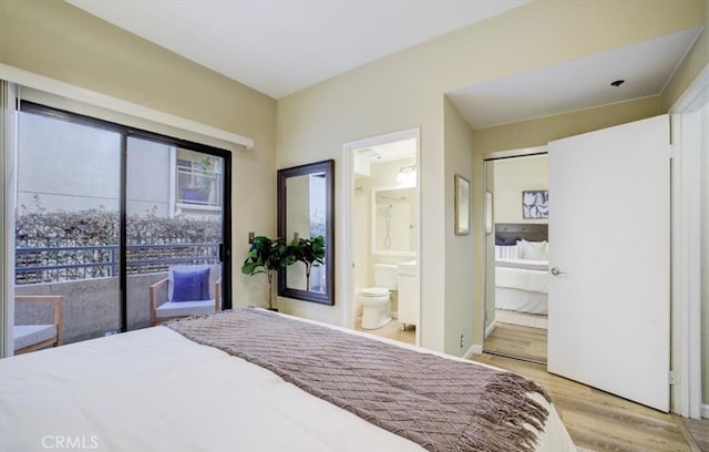 bedroom featuring light wood finished floors and connected bathroom