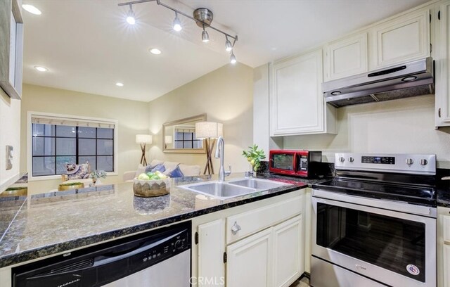 kitchen featuring appliances with stainless steel finishes, kitchen peninsula, white cabinetry, and sink