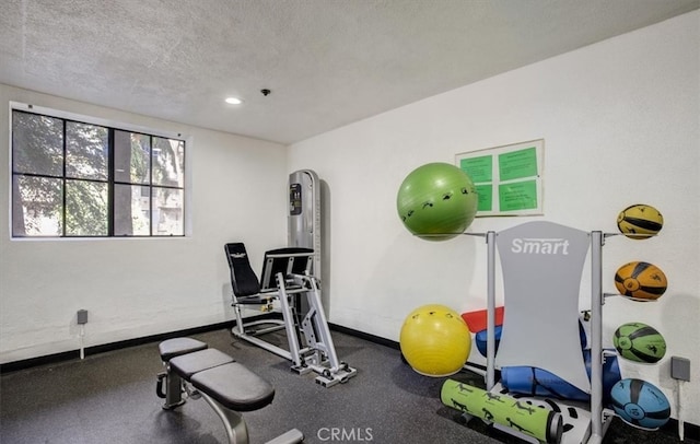 workout room with a textured ceiling