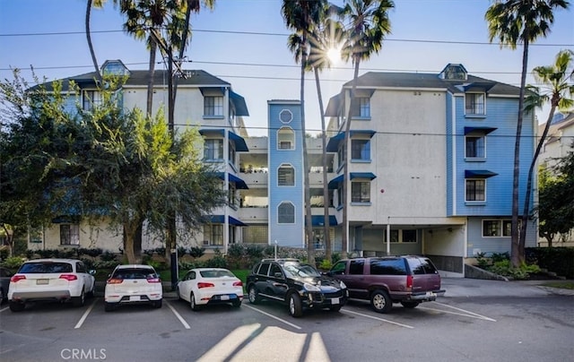 view of building exterior with uncovered parking