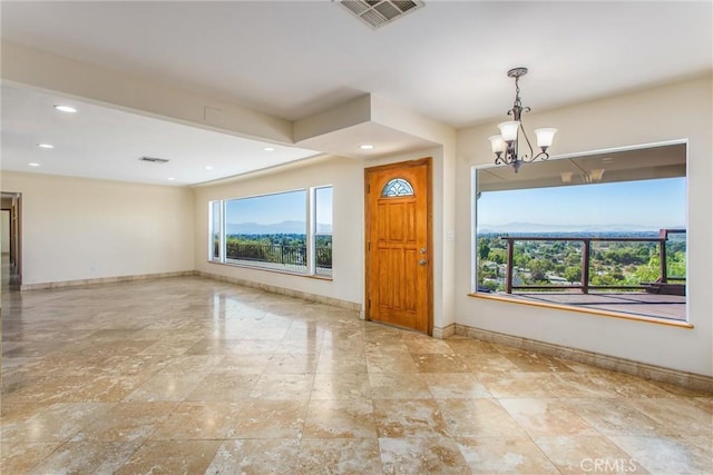 entrance foyer featuring a mountain view and a notable chandelier